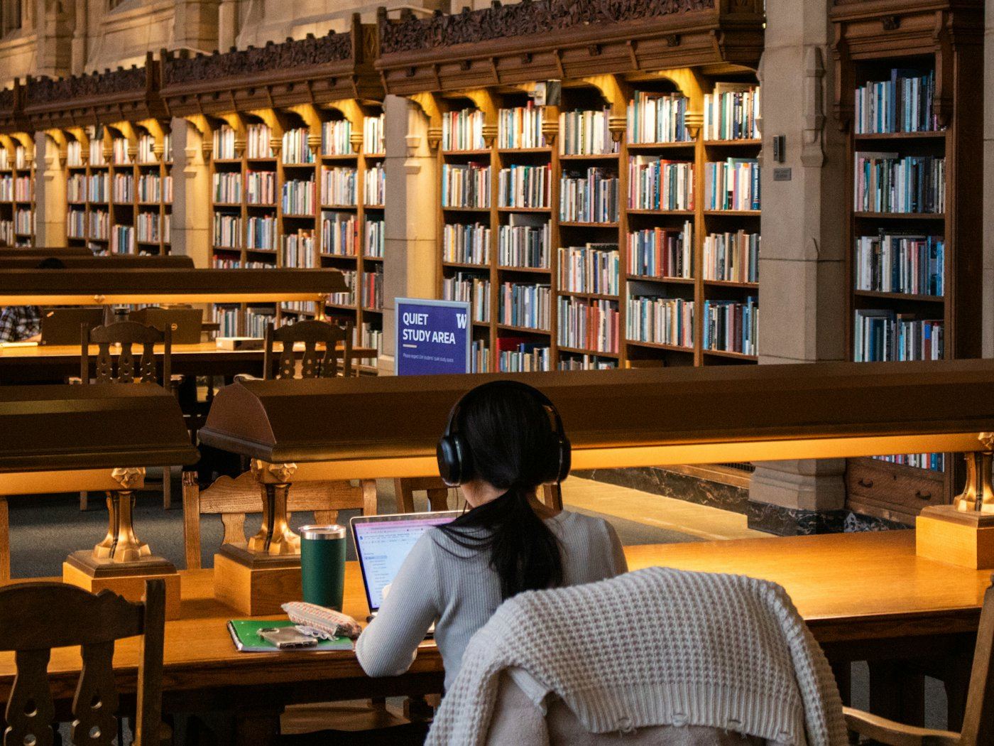 A student studying at a library table